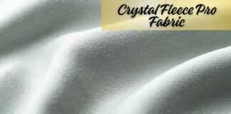 Crystal Fleece Pro Fabric: Premium Warmth and Comfort Guide "Close-up of light grey woven fabric with soft folds and subtle texture. A gold banner in the top right corner displays the text 'Crystal Fleece Pro Fabric' in cursive." Crystal Fleece Pro Fabric: