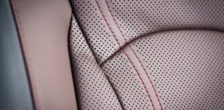 Swift Fit Dynamic Fabric: A Game-Changer in Modern Textiles "Close-up of perforated light brown leather with red stitching. The coat panels are outlined by visible red stitches, showing texture and construction details." Swift Fit Dynamic Fabric: