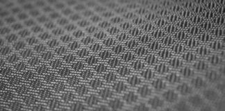 WarmTech Elite Athletic Weave: Next-Gen Athletic Fabric Tech Alt text: Close-up of a black-and-white woven fabric with a diagonal pattern. The interlaced threads create a textured surface, with shallow depth of field. WarmTech Elite Athletic Weave: