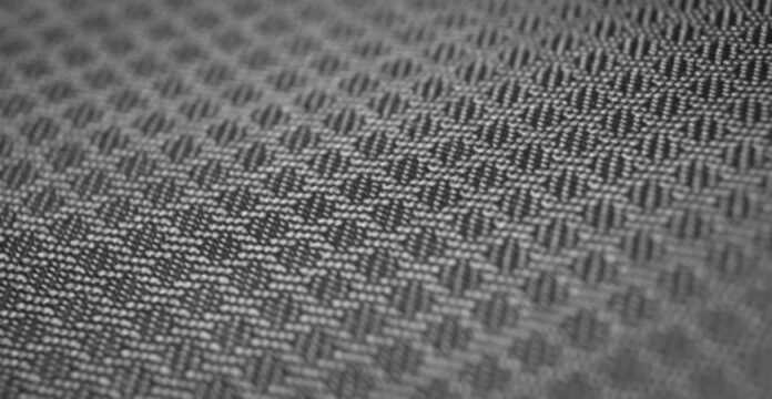 Alt text: Close-up of a black-and-white woven fabric with a diagonal pattern. The interlaced threads create a textured surface, with shallow depth of field. WarmTech Elite Athletic Weave: