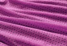 Fresh Vent Breathable Sports Cloth: Stay Cool While Active "Close-up of wrinkled purple fabric with small, evenly spaced perforations." Fresh Vent Breathable Sports Cloth: