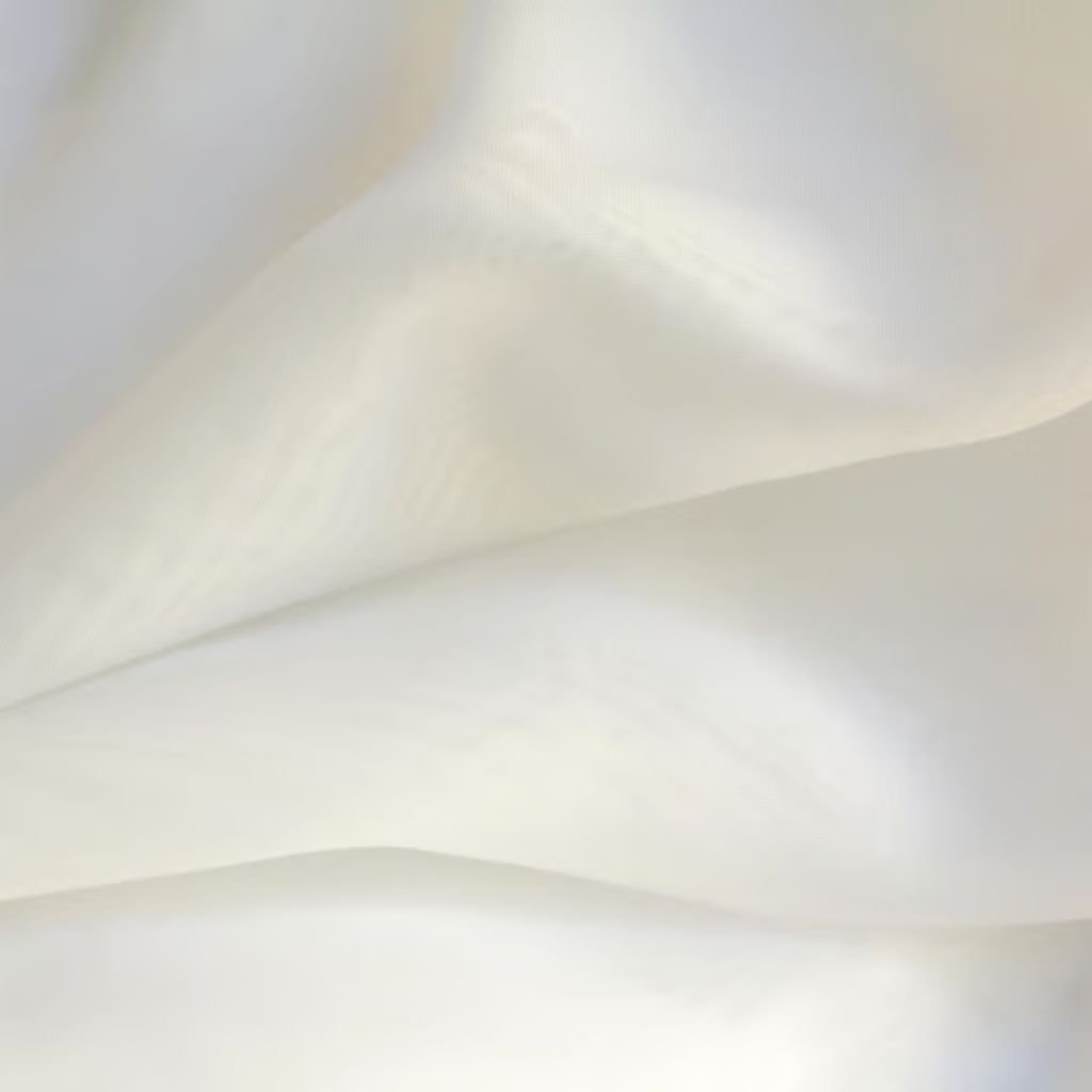 Alt text: Close-up of a semi-transparent off-white fabric with undulating folds and soft lighting that highlights gentle curves.
Snow Silk Luxe Winter Weave: