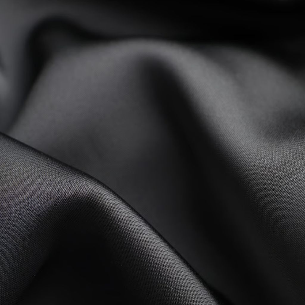 What Is Arctic Fusion Tech Fabric? Features, Benefits & Uses 9 Alt text: Close-up of black silk fabric with soft folds. The material has a subtle sheen, with highlights and shadows emphasizing its texture and depth.
What Is Arctic Fusion Tech Fabric?