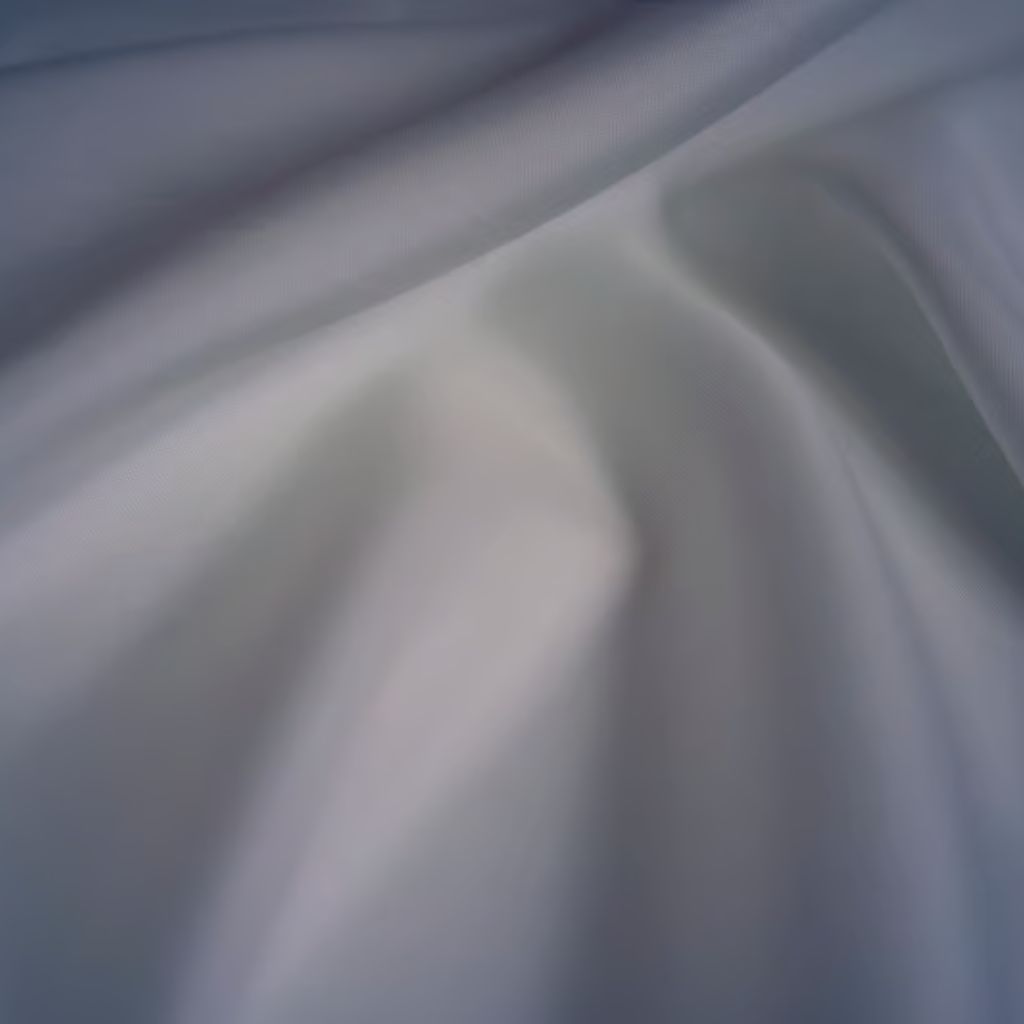 Close-up of light gray fabric with soft folds and creases, creating flowing texture and subtle depth from gentle lighting.

Snow Aura Premium Shield Fabric: