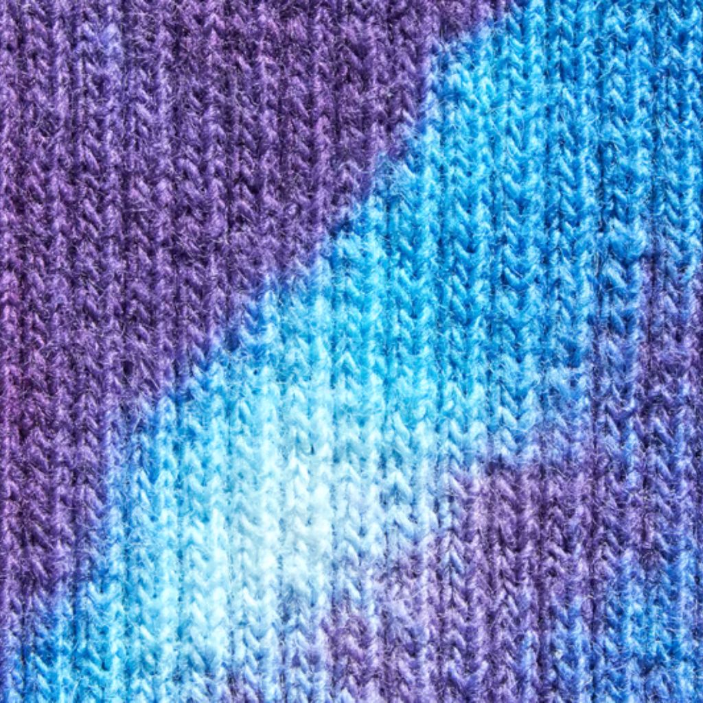 "Close-up of knitted fabric with vertical purple, light blue, and white stripes creating a tie-dye effect."

Glacier Soft Elite Knit Explained: