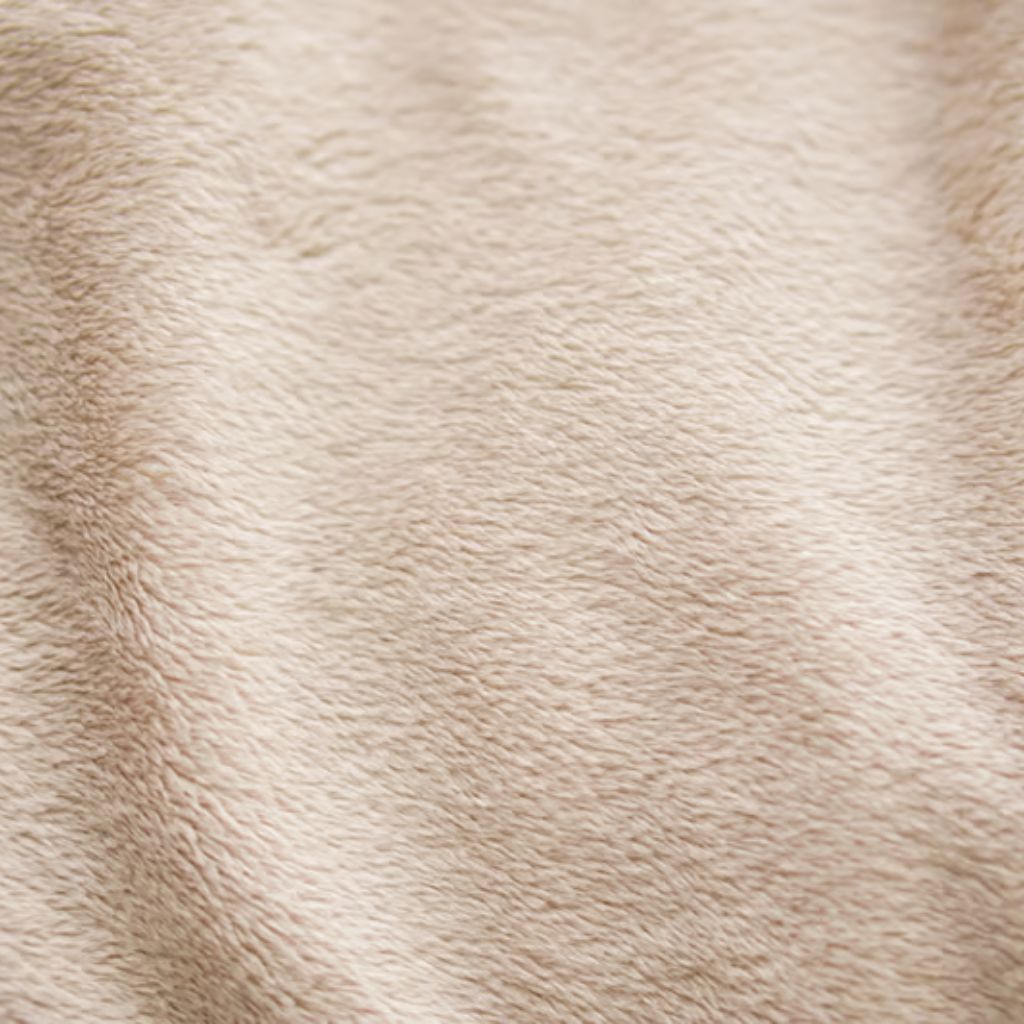 Close-up of a light beige textured fleece blanket with a soft, plush surface and visible pile creating depth and shadows.
Nordic Plush Thermal Fabric Explained: