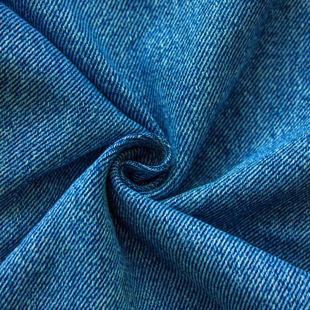 Ultra Motion Stretch Fabric: Performance, Durability & Style 8 Close-up of blue denim fabric with a twill weave folded in a spiral, showing texture and color variation.
Ultra Motion Stretch Fabric: