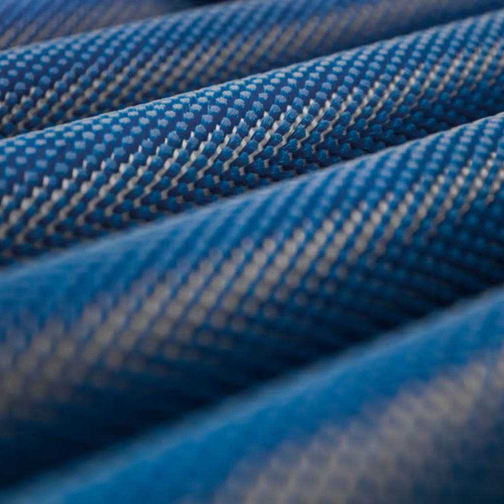 Close-up of several parallel blue ropes with a grid of small white dots, curved and creating soft shadows.
Aero Flex Pro Fabric: