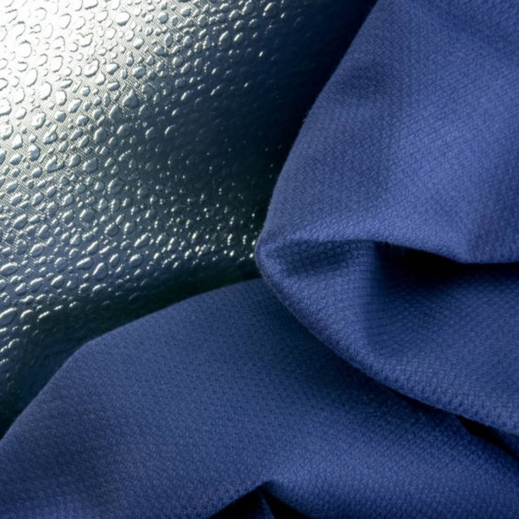 Close-up image showing a textured metallic surface with small bumps on the left and a navy blue fabric with folds on the right.
What Is Cryo Comfort Winter Fabric?