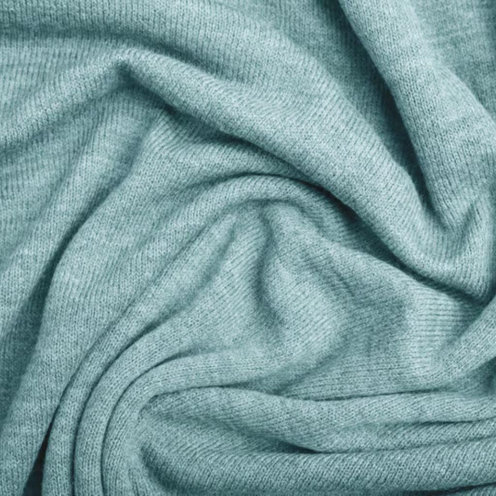 Frost Flex Stretch Thermal Fabric: Warmth Meets Flexibility 9 Alt text: A close-up view of light blue knitted fabric, softly draped and folded into swirling patterns, with visible fine knit texture.
Frost Flex Stretch Thermal Fabric: