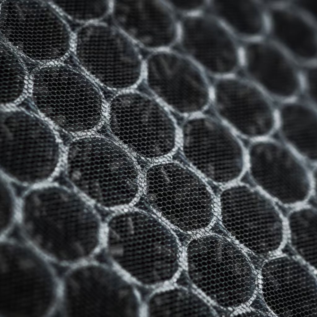 Close-up of a black honeycomb-patterned air filter with interconnected cells and a sense of depth.
Aero Flex Pro Fabric: