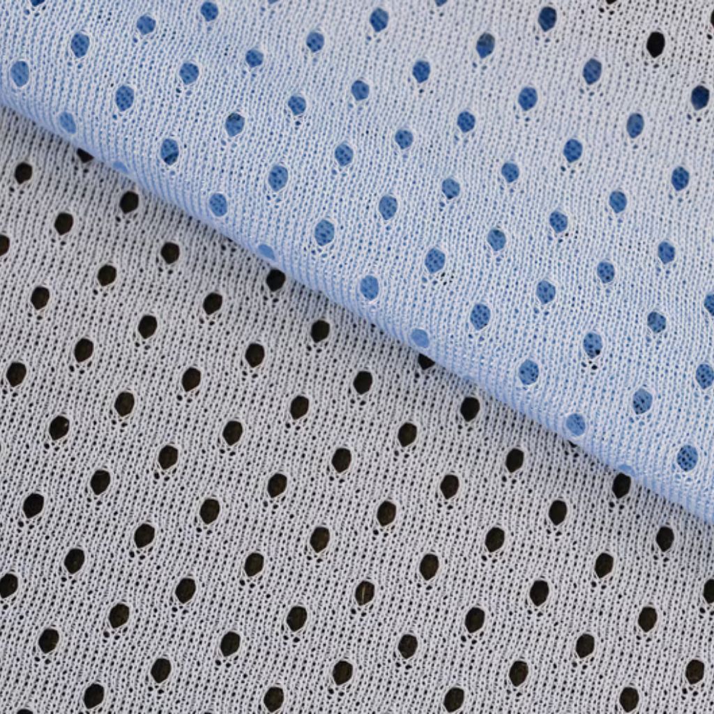 Fresh Vent Breathable Sports Cloth: Stay Cool While Active 10 "Close-up of two layered fabrics with a mesh texture and circular perforations. The top-right fabric is light blue with dark blue holes; the bottom-left fabric is white with black holes."
Fresh Vent Breathable Sports Cloth: