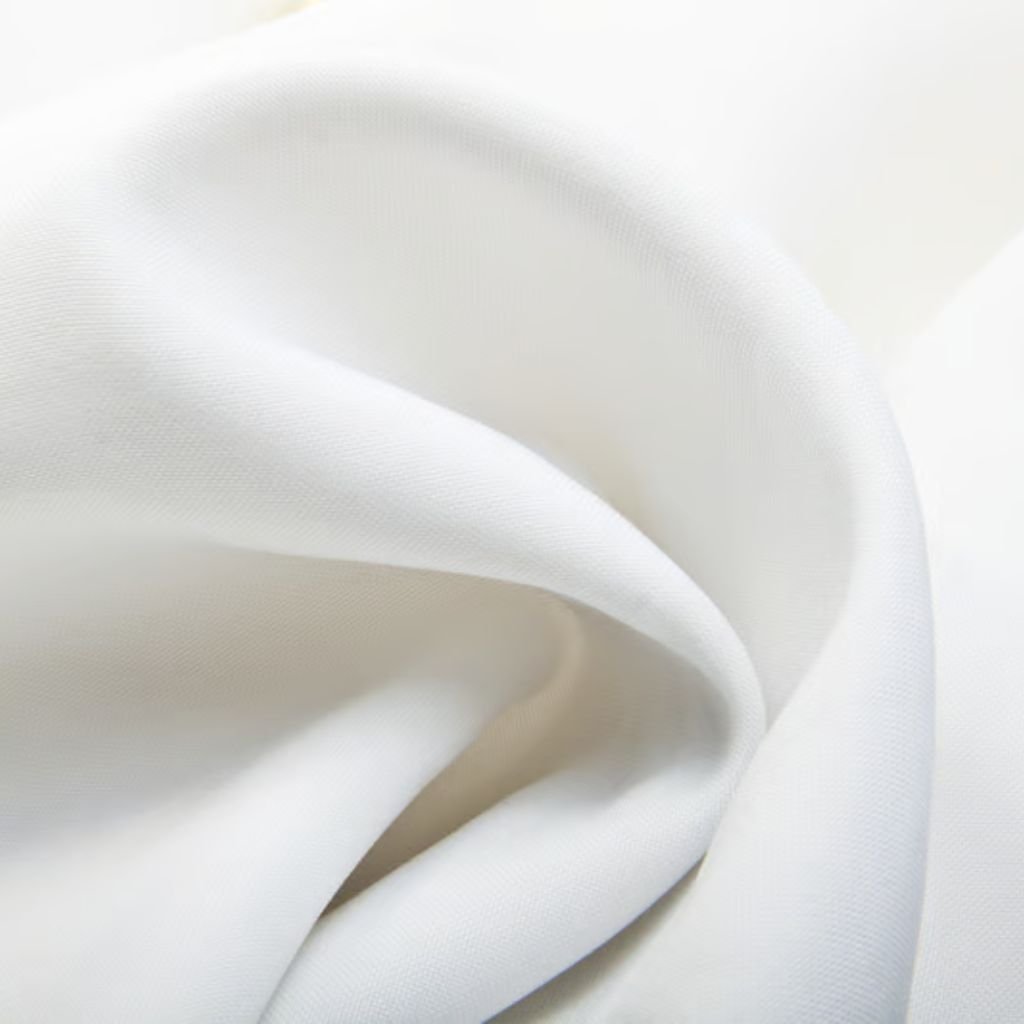 Snow Silk Winter Fabric: The Future of Cold-Weather Comfort 12 Alt text (short, screen-reader friendly): A close-up of smooth white fabric softly folded, with gentle lighting and subtle shadows.
Snow Silk Winter Fabric: