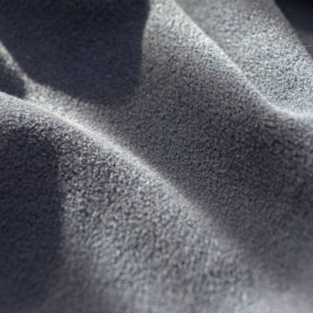Close-up of gray fleece fabric with soft, rippling folds and partial lighting creating highlights and shadows.
What Is Cryo Comfort Winter Fabric?