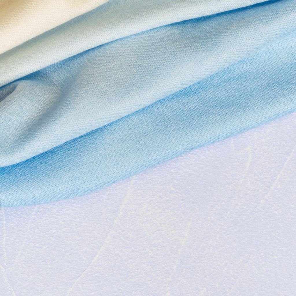 Snow Silk Winter Fabric: The Future of Cold-Weather Comfort 7 Alt text (short, screen-reader friendly): Close-up of soft fabric in light blue tones draped across a white surface.
Snow Silk Winter Fabric: