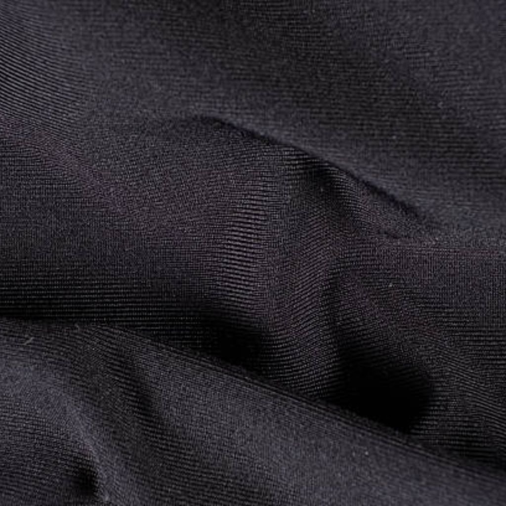Alt text: Close-up of dark black ribbed fabric with multiple folds and creases creating a textured surface.
What Is Thermal Core Elite Fabric?
