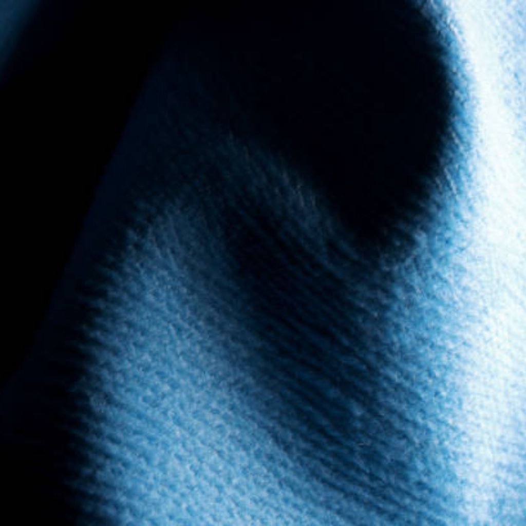 Close-up view of blue woven fabric with dark shadows and bright highlights, showing a textured surface.
What Is Cryo Comfort Winter Fabric?