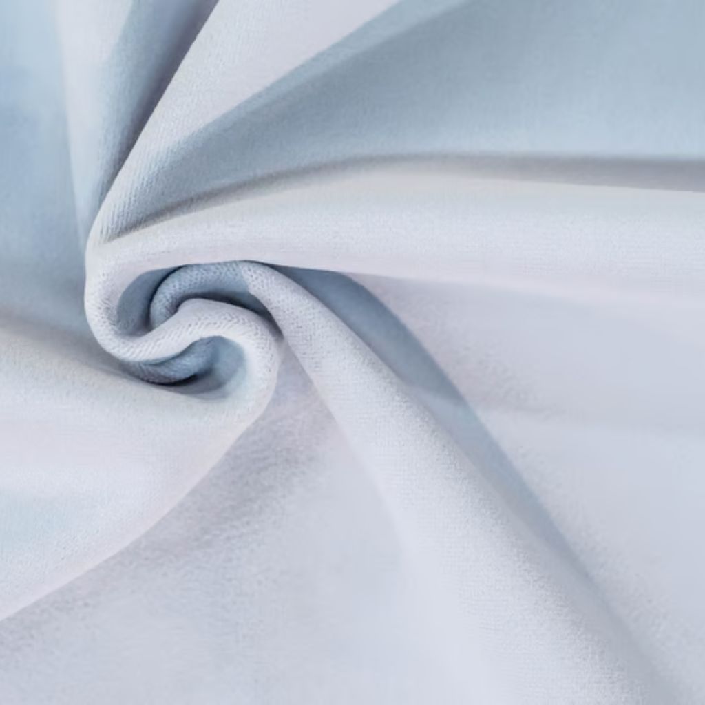 Close-up of plush white fabric draped into a swirl, with soft textures and diffused lighting creating gentle gradients and pale blue shadows.

Snow Aura Premium Shield Fabric: