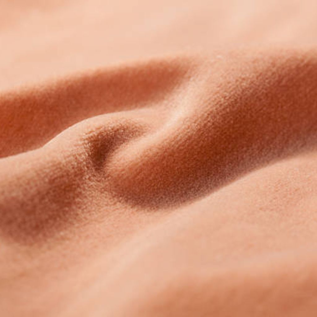 Close-up of peach-colored velvety fabric with soft folds and fine texture.
Polar Velvet WarmTech Fabric Explained:
