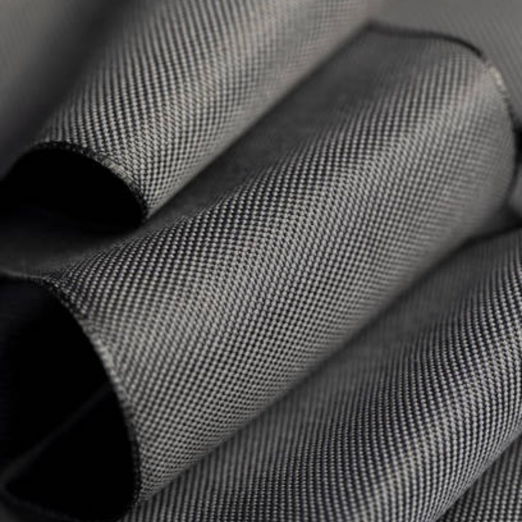 Thermo Shield Performance Fabric: Technology for Activewear 7 Close-up of tightly woven textured fabric with a repeating light/dark thread pattern and soft curved folds.
Thermo Shield Performance Fabric:
