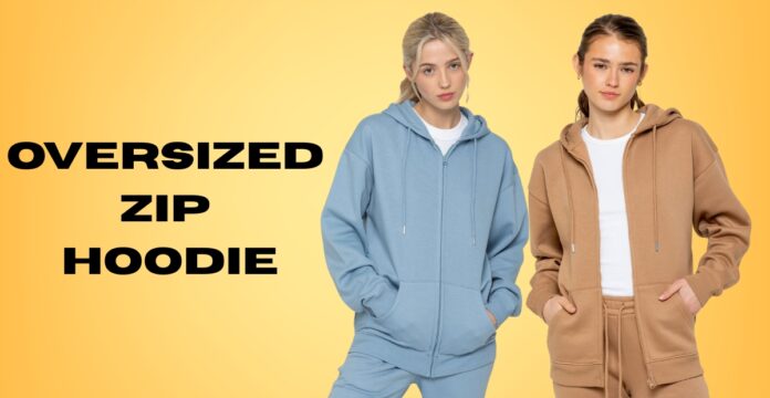 Two models wearing oversized zip hoodies and matching sweatpants stand against a yellow gradient background. The model on the left wears a light blue set with hands in pockets; the model on the right wears a tan/brown set with hands in pockets.