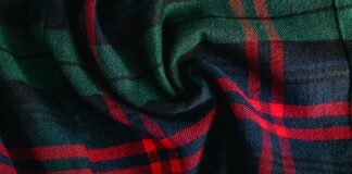 Printed Grade B Cashmere Fabric: Affordable Luxury Style Printed Grade B Cashmere Fabric Printed Grade B Cashmere Fabric Close-up of twisted plaid fabric in green, red, and dark blue with woven texture.