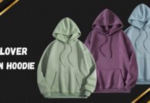 The Essential Pullover Plain Hoodie: Style Guide Three pullover plain hoodies in light green, purple, and light blue lined up against a dark chevron background with gold diagonal accents; each hoodie has a drawstring hood and a front kangaroo pocket.