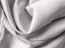 Recycled Cashmere Twill Fabric Close-up of light gray woven fabric with soft folds and visible texture.