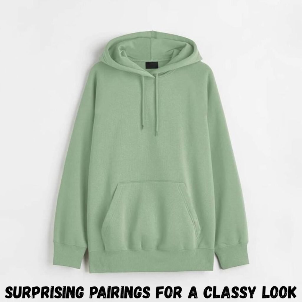 A light green hoodie with a front kangaroo pocket and drawstrings on the hood, displayed against a white background. Zip-up plain hoodie