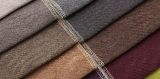 Types of Grade B Cashmere Wool Fabric Explained Close-up view of diagonal fabric swatches in various colors (gray, brown, beige, purple, burgundy, and green) with visible stitching along some edges. The fabrics have a coarse texture and are arranged in a stacked display.