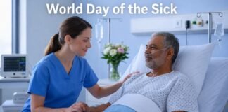 World Day of the Sick 2026: Raising Awareness and Compassion A nurse in blue scrubs sits beside an elderly male patient in a hospital bed, holding his hand. The patient wears a nasal cannula and looks at the nurse; medical equipment and flowers are visible in the background, with a banner promoting World Day of the Sick.
