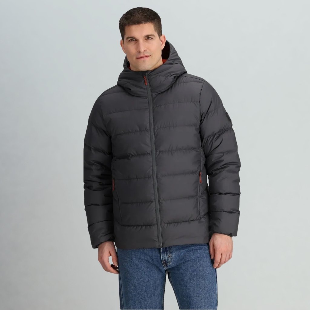  A man stands against a neutral backdrop wearing a Coldfront   jacket with a hood. The jacket is zipped up, the hood is up with an orange lining visible, and he is wearing blue jeans while looking toward the camera.