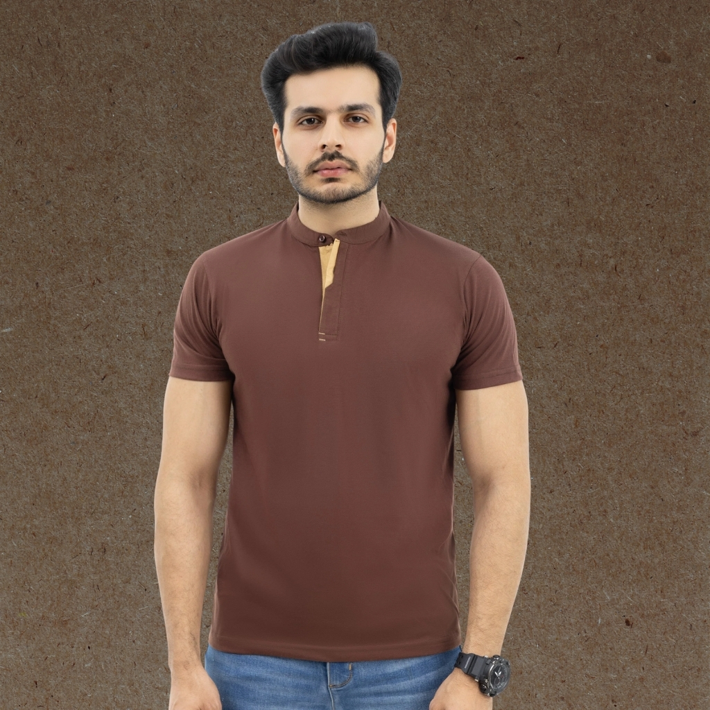What Is a T-Shirt , Types and Style Guide 15 Man wearing a brown Henley T-shirt with a buttoned neckline, paired with blue jeans.