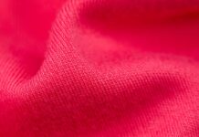 Power Stretch Active Fabric: Boost Performance with Flex Fit “Close-up of bright red, textured fabric with folds and soft shadows.” Power Stretch Active Fabric:
