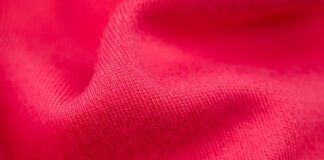 Power Stretch Active Fabric: Boost Performance with Flex Fit “Close-up of bright red, textured fabric with folds and soft shadows.” Power Stretch Active Fabric: