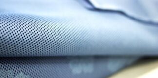 Breeze Tech Training Fabric: Lightweight & Breathable Power “Close-up of blue fabric with small perforated holes, likely a quilted or textured winter coat material.” Breeze Tech Training Fabric: