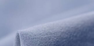 Frost Flex Active Fabric: Stay Cool During Intense Workouts Alt text: “A close-up view of a soft, blue knit fabric that resembles the texture of a winter coat or warm fleece, with a rolled edge in the foreground.” Frost Flex Active Fabric: