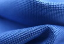 Rapid Dry Sports Fabric: High-Performance Athletic Material “Close-up of blue fabric with a textured, grid-like weave, likely from a winter coat.” Rapid Dry Sports Fabric: