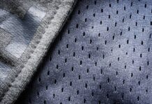 Hyper Flex Motion Knit: Engineered for Ultimate Flexibility Close-up of breathable mesh performance fabric with small perforations for airflow and moisture control.Hyper Flex Motion Knit: