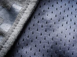 Close-up of breathable mesh performance fabric with small perforations for airflow and moisture control.Hyper Flex Motion Knit: