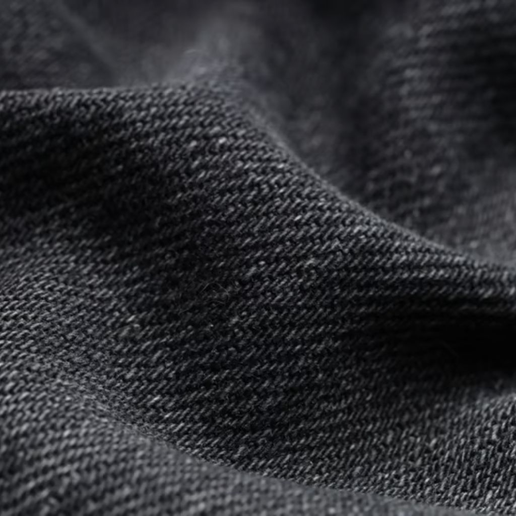 “Close-up of folded gray woven fabric with a slightly rough texture and soft draped lines.”
Power Stretch Active Fabric:
