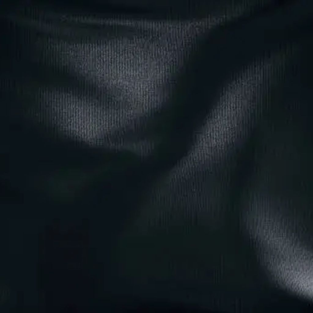 Close-up of dark, ribbed fabric draped with glossy highlights and shadows, showing folds and curved surfaces.
Power Stretch Active Fabric:
