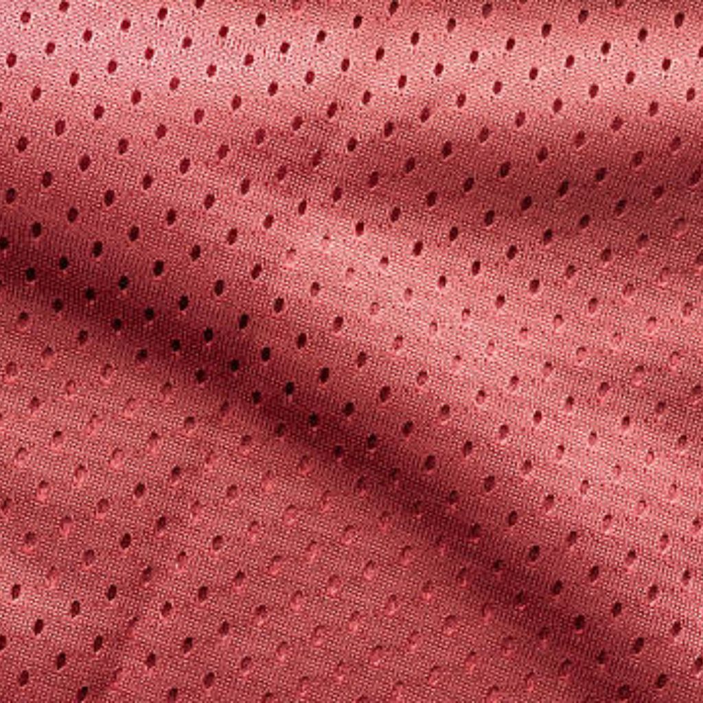 Close-up of red mesh fabric with small, evenly spaced holes and subtle shadows that create depth and texture.
Fresh Flow Athletic Fabric: