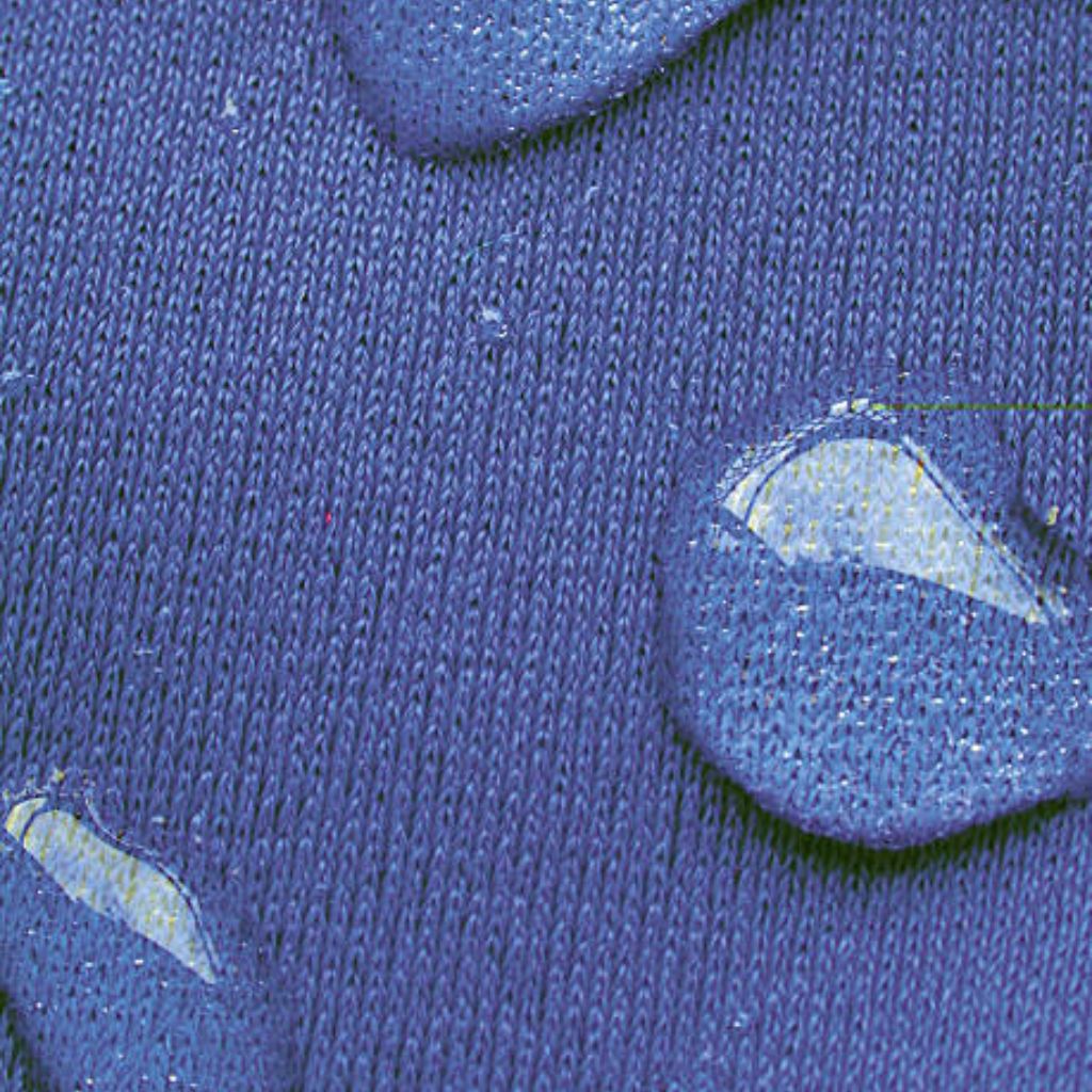 Alt text: Close-up of blue woven fabric with reflective water droplets Beading on the surface; fabric texture clearly visible.
Chill Tech Moisture Control Fabric: