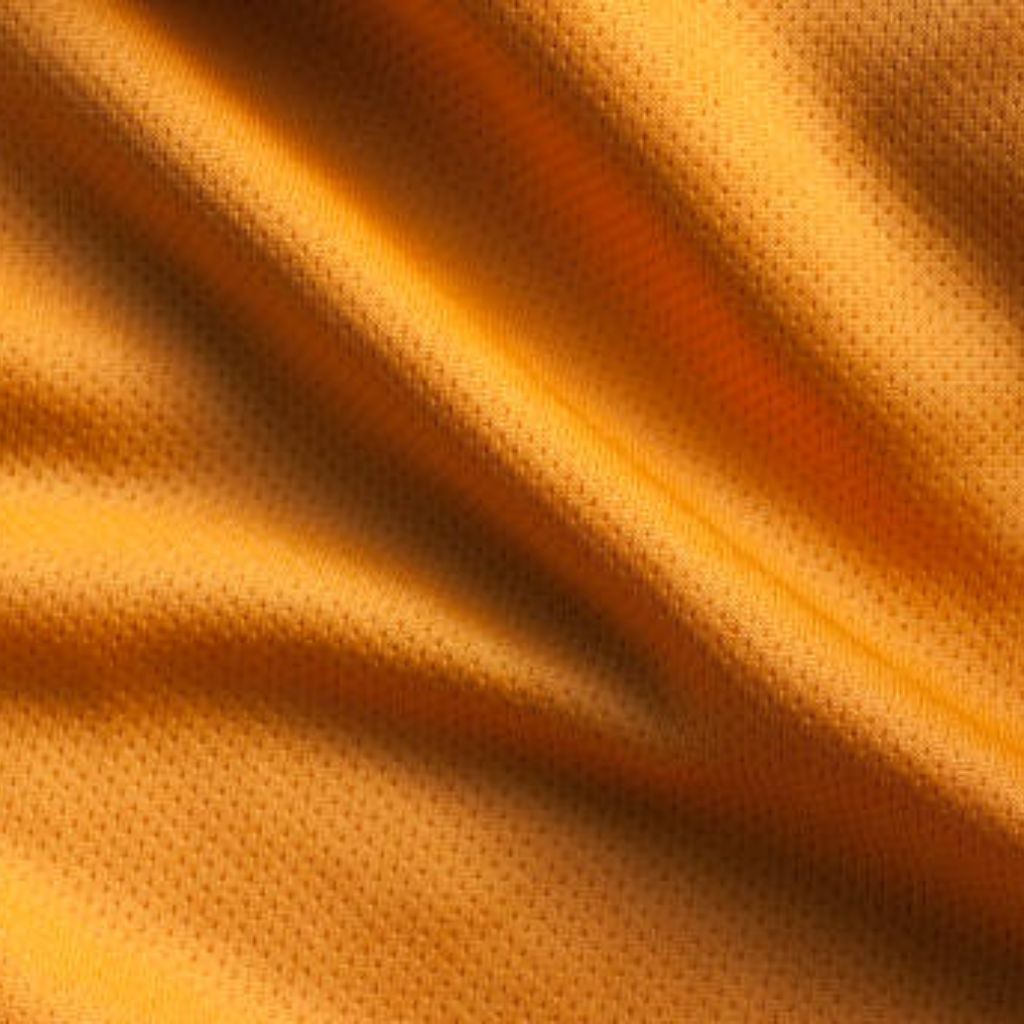 MotionX Breathable Sports Fabric: Performance Meets Comfort 9 "Close-up of golden yellow fabric with a waffle or small mesh weave, draped in soft curved folds that create depth and highlight the texture."
MotionX Breathable Sports Fabric: