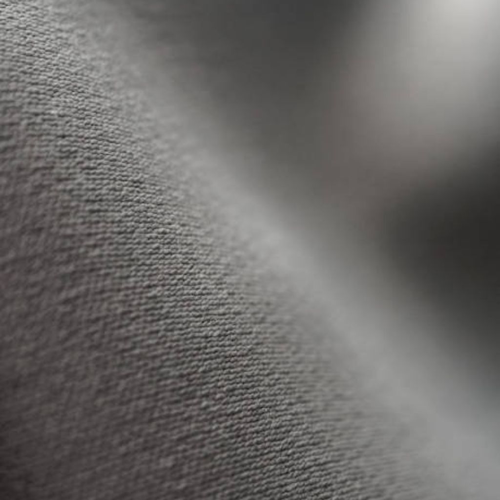 Close-up of a textured fabric in grayscale, showing fine weave and soft folds, with a shallow depth of field.

Sweat Flow Pro Fabric: