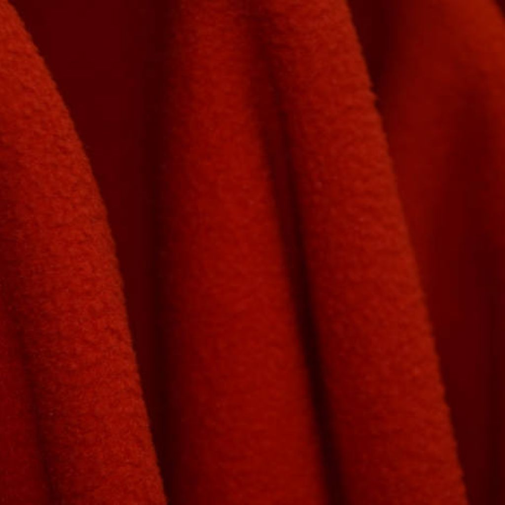 Close-up of a military-inspired winter jacket fabric in dark tones with red accents and a rugged, textured surface.
Arctic Cool Performance Fabric: