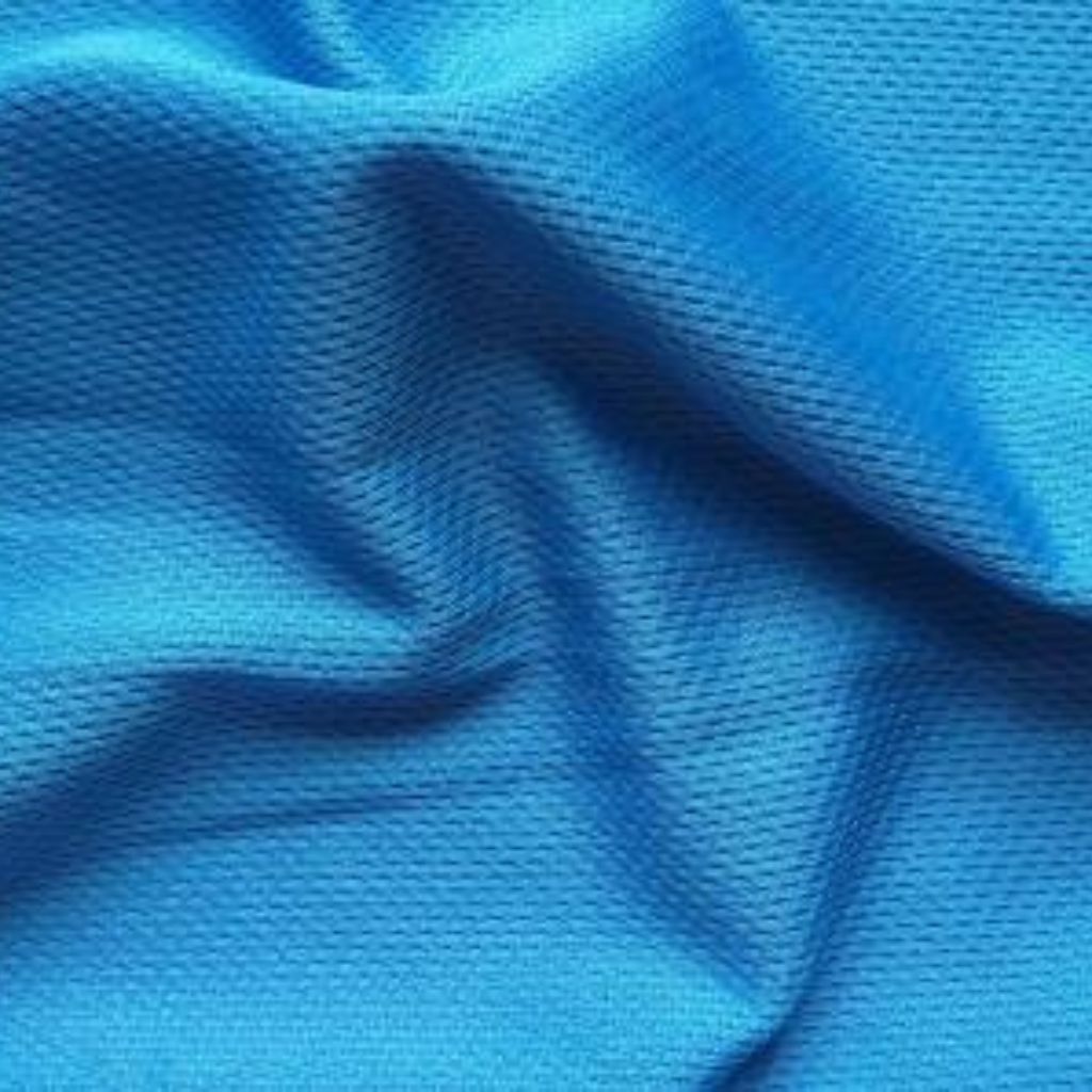 Ice Flow Athletic Fabric: Stay Cool During Intense Workouts 9 Close-up of bright blue fabric with a textured knit pattern and soft folds.
Ice Flow Athletic Fabric: