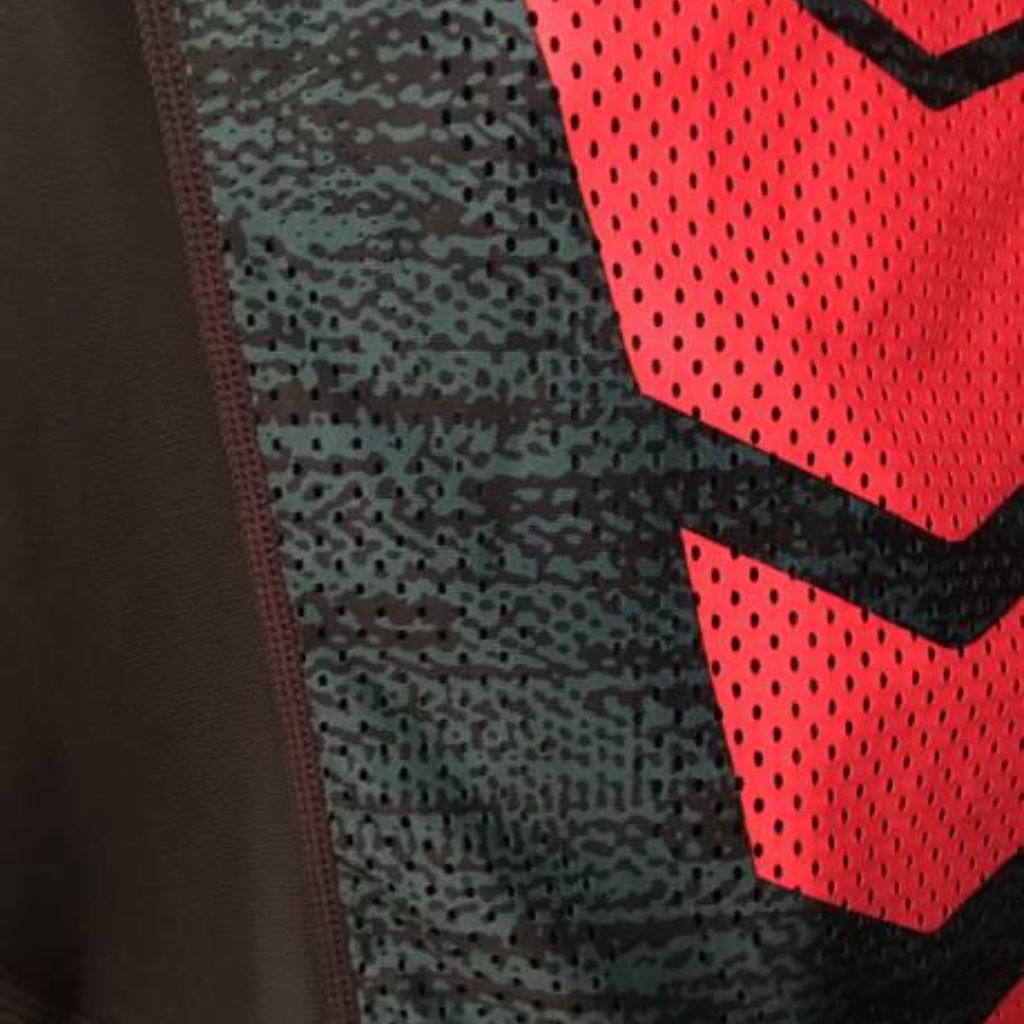 Close-up of fabric with a red mesh pattern forming an arrow design, adjacent to a green patterned mesh and a solid dark fabric panel on the side.
ProFit Compression Tech Fabric