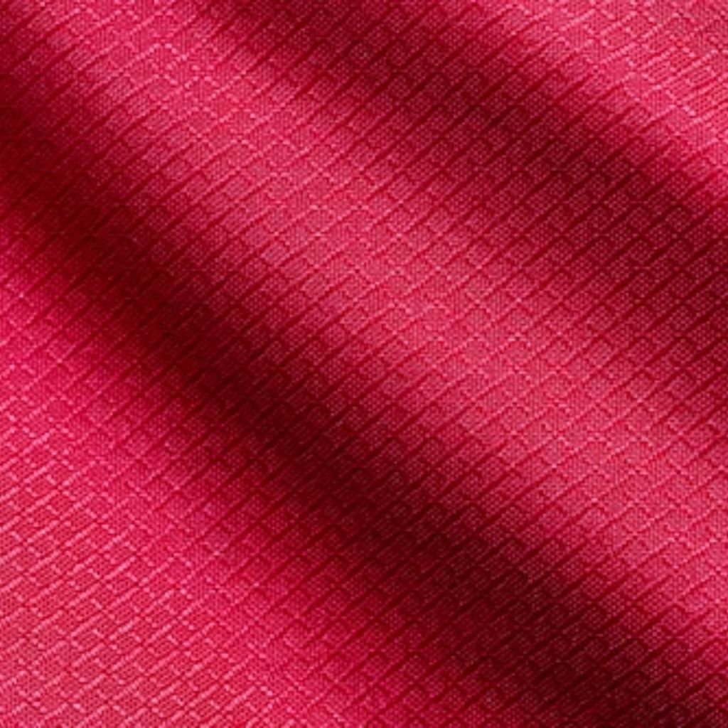 "Close-up of deep red technical fabric with raised diamond-quilted pattern showing light reflection and dimensional texture"

Air Weave Performance Fabric: